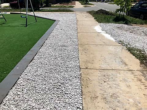 Cleared and tidied garden bed with new pebbles