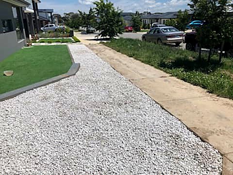 Neatly edged garden bed beside a driveway