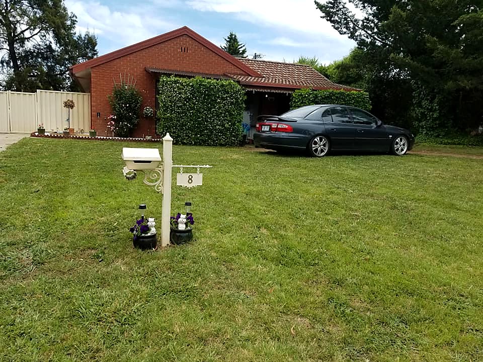 Mown front lawn and tidy garden at a Canberra home